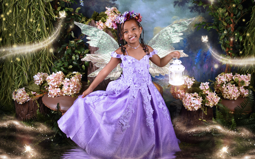 young child in purple gown fairy photoshoot